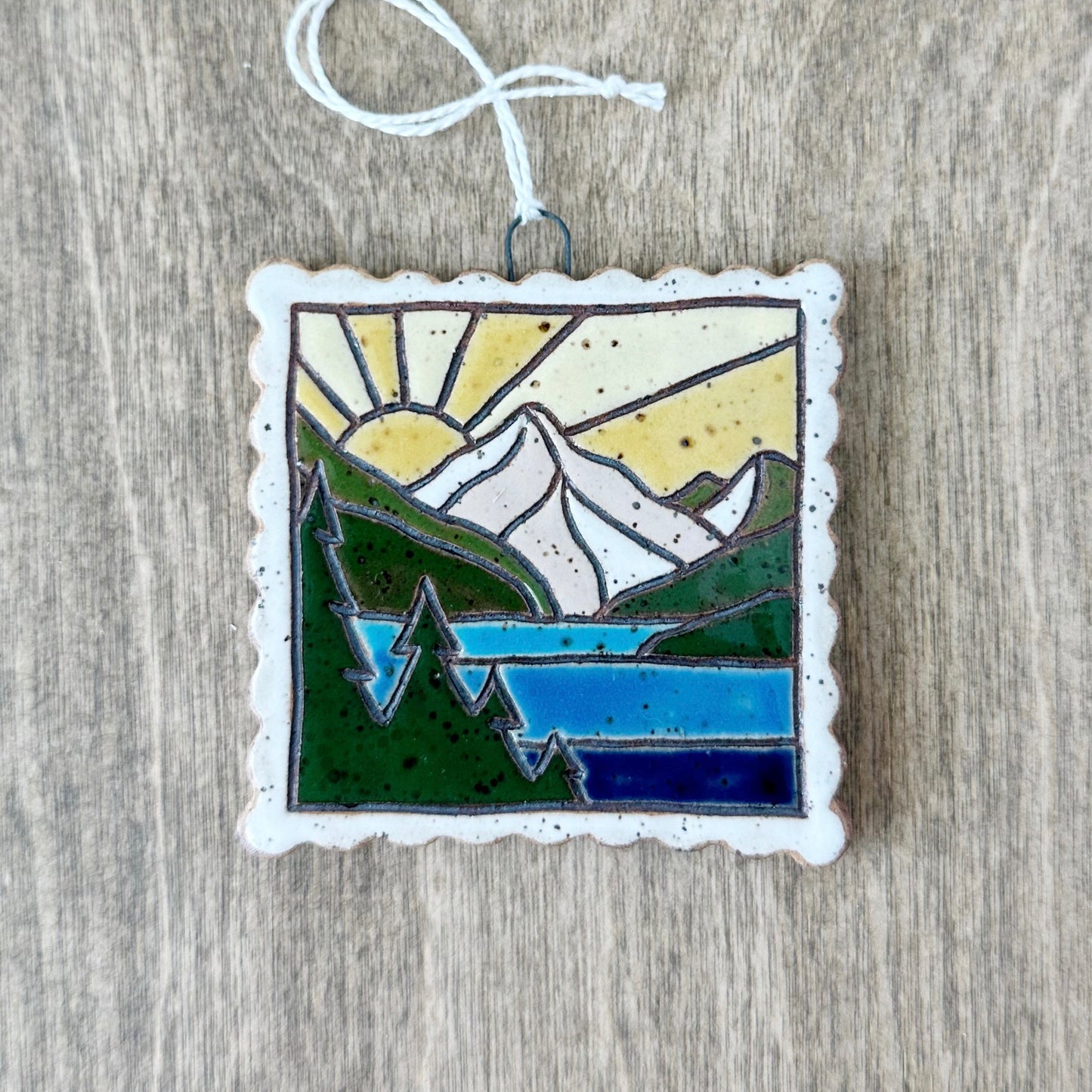 sun over mountain lake stamps